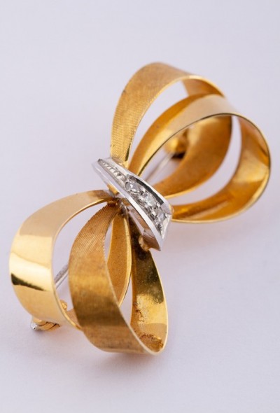 Gouden strik broche met diamanten